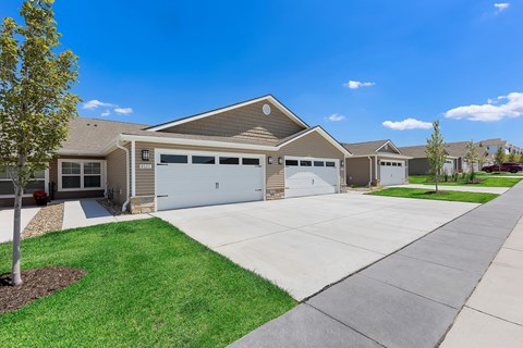 A house with a brown roof and a white garage door.