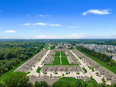 A suburban neighborhood with a large green space in the center.