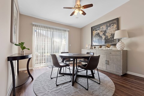 A dining room with a table set for four.