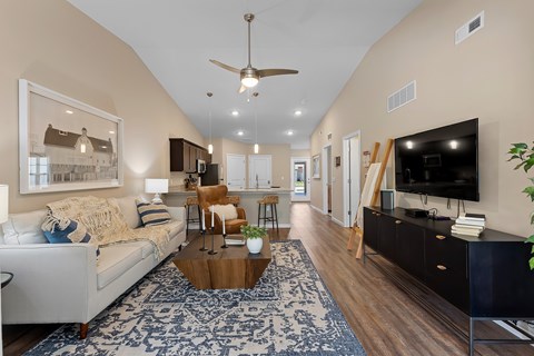 A living room with a white couch and a coffee table.
