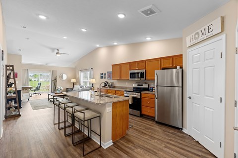 A kitchen with a white refrigerator and wooden cabinets.