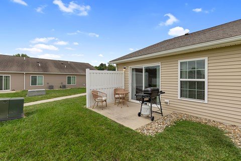A house with a patio and a chair set.