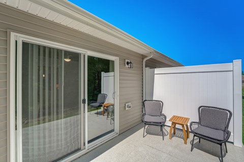 A patio with a table and two chairs.