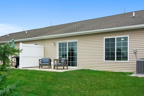 A house with a white garage door and a brown roof.