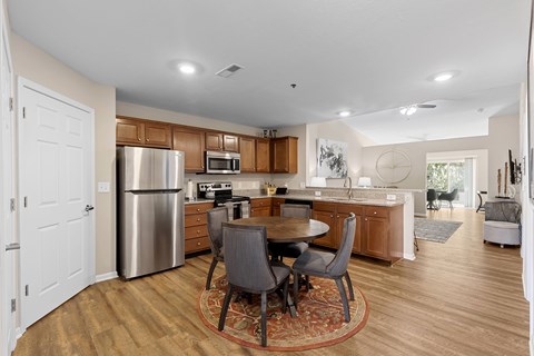 A kitchen with a table and chairs in the middle of the room.