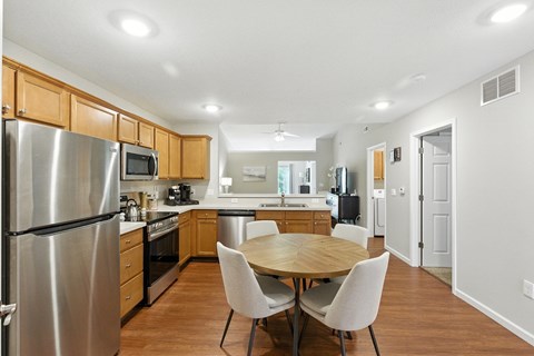 A modern kitchen with a table and chairs.