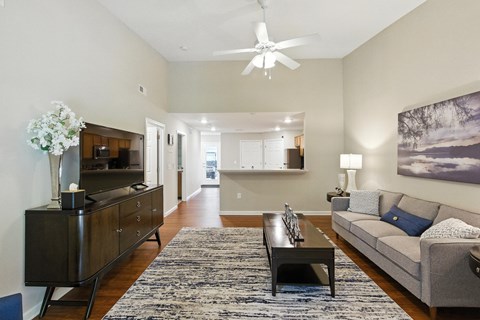A living room with a grey couch and a coffee table.