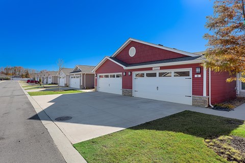 A red barn-style building with a white garage door is labeled "CARROT".