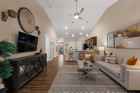 A living room with a white couch and a wooden floor.