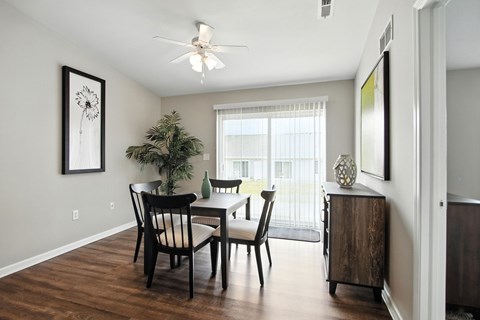 A dining room with a table and chairs.