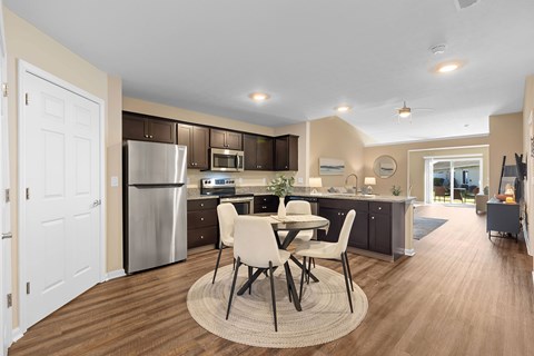 A modern kitchen with a dining table and chairs.