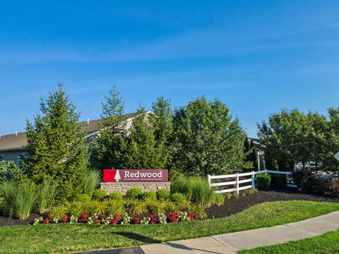 A sign that says Redwood in front of a building.