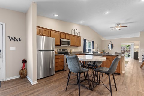 A modern kitchen with a dining table and chairs.
