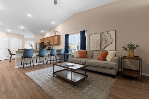 A living room with a grey couch and a coffee table.
