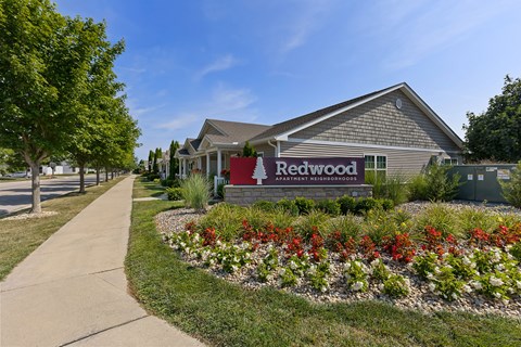 A building with a sign that says Redwood in front of it.