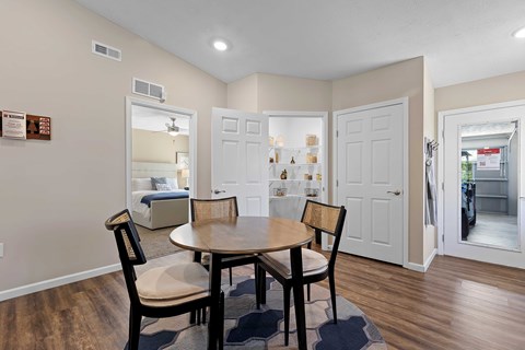 A dining room with a table and chairs.