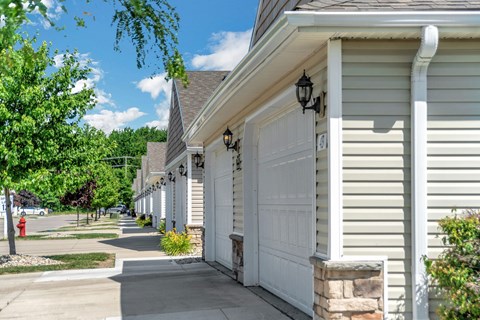 A row of houses with white garage doors.