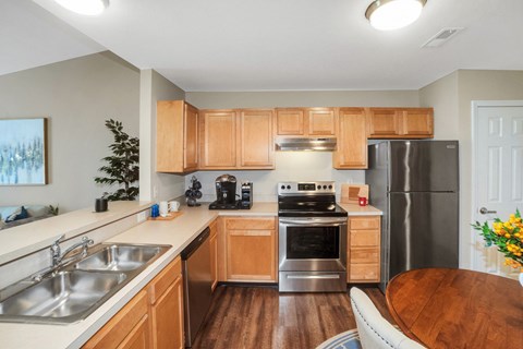 A kitchen with wooden cabinets and stainless steel appliances.