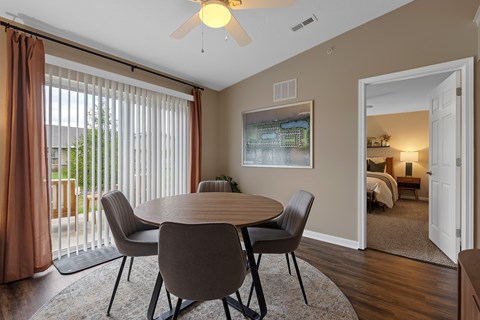 A dining room with a table and chairs.