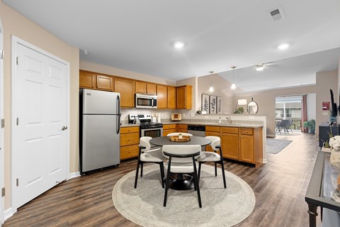 A kitchen with a table and chairs in the middle of the room.