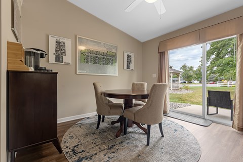 A dining room with a table and chairs.