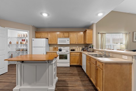 A kitchen with wooden cabinets and a white refrigerator.