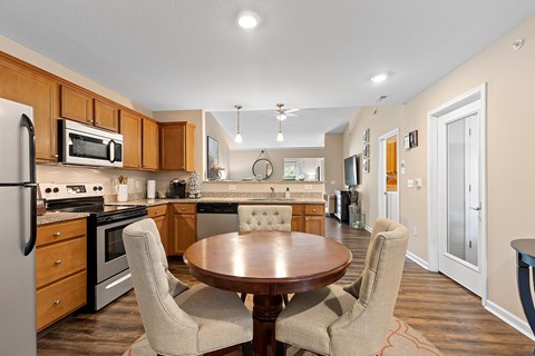 A kitchen with a table and chairs in the middle of the room.