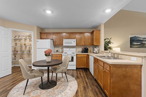 A kitchen with a table and chairs in the middle of the room.