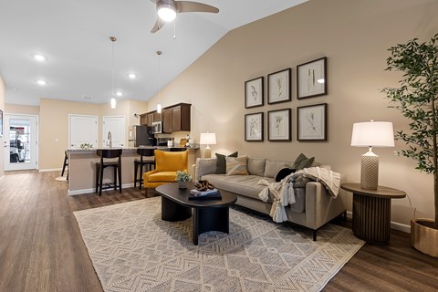 A living room with a grey couch and a coffee table.