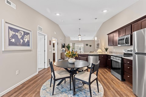 A kitchen with a table and chairs in the middle of the room.
