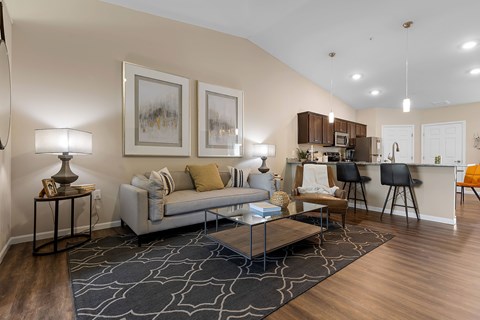 A living room with a grey sofa and a coffee table.