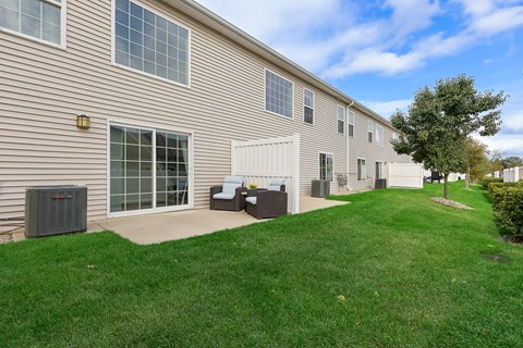 A building with a green lawn in front.