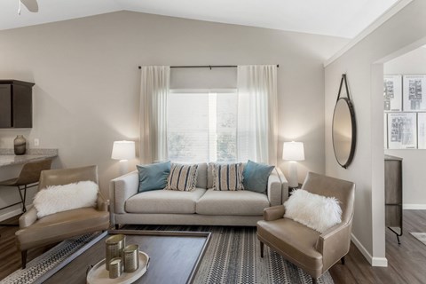 A living room with a grey couch and a coffee table.
