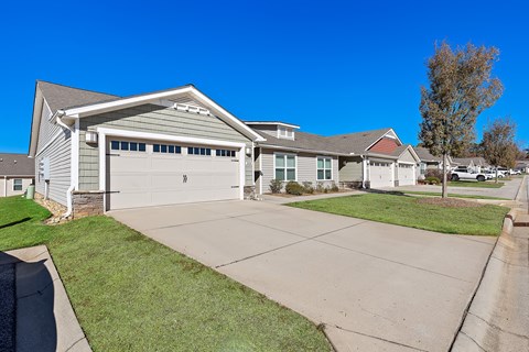 A house with a grey garage door and a grey roof.