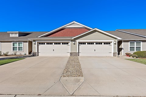 A house with a red tile roof and two garages.