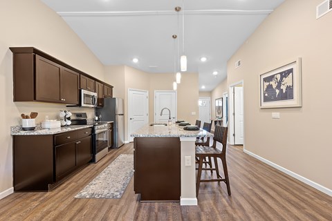 A kitchen with brown cabinets and a white island.