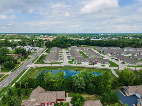 A bird's eye view of a suburban neighborhood with a swimming pool.