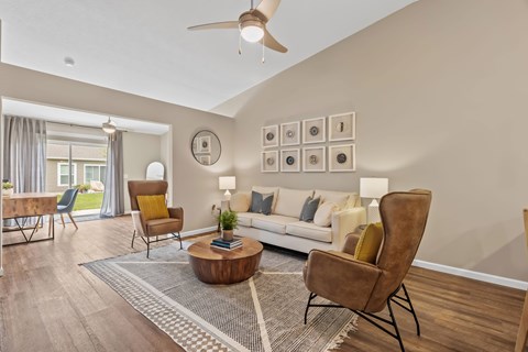 A living room with a brown chair and a white couch.