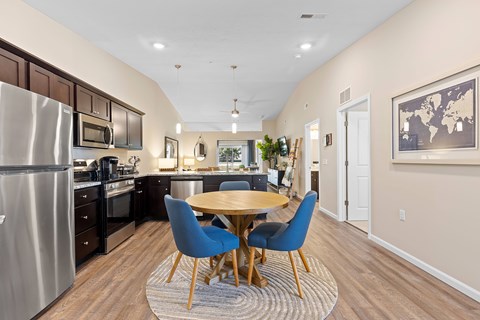 A modern kitchen with a dining table and chairs.