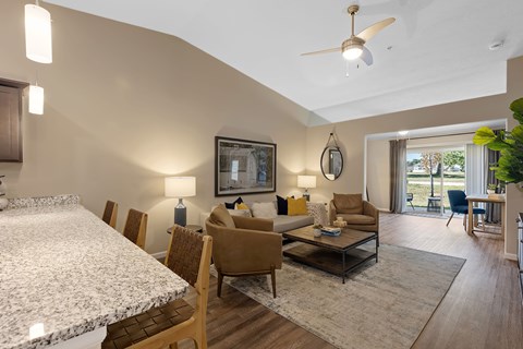A well-lit living room with a dining table and chairs.