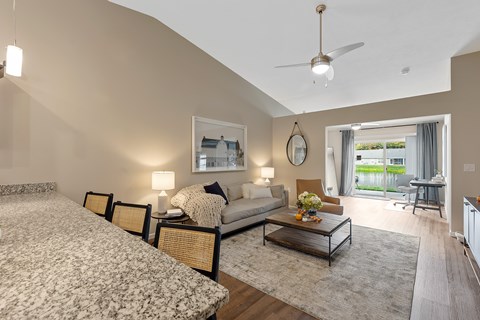 A bedroom with a large bed and a couch with a coffee table in between.