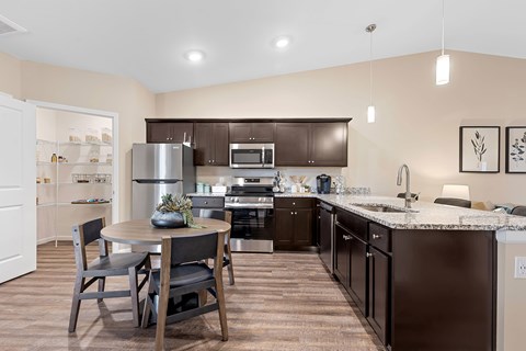 A kitchen with brown cabinets and a white refrigerator.