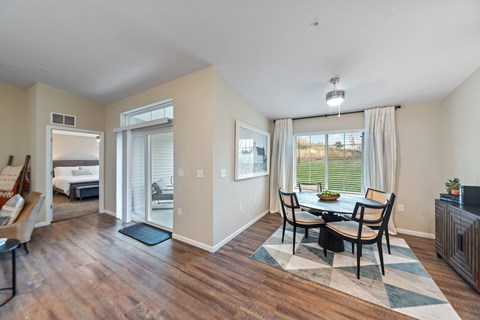 A dining room with a table set for four.