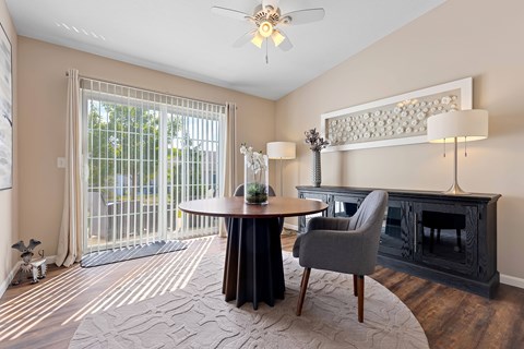 A living room with a grey chair and a black table.