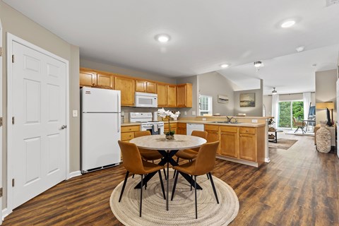 A kitchen with a table and chairs in the middle of the room.