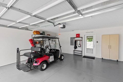 A red golf cart is parked inside a building.