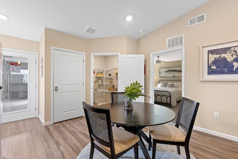 A dining room with a table and chairs.