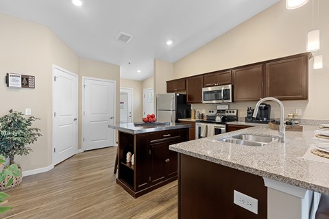 A kitchen with brown cabinets and a white countertop.