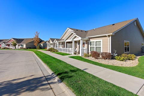 A row of houses with a clear blue sky above them.