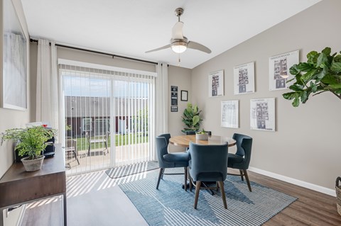 A dining room with a table set for four.